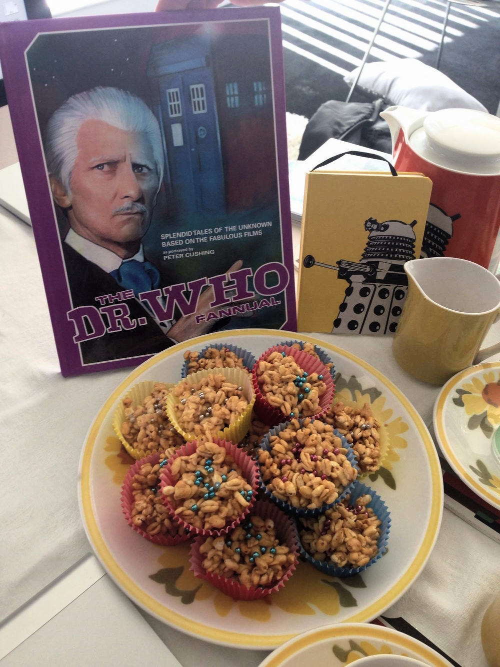 A plate of sugar puff treats next to the Dr Who Peter Cushing fannual